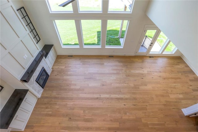 bonus room with a high ceiling and light hardwood / wood-style flooring