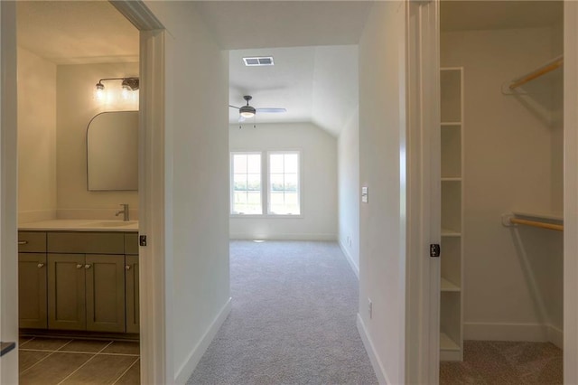 interior space featuring tile patterned flooring, ceiling fan, and vanity