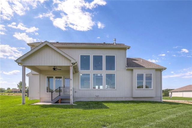 rear view of house with a lawn and ceiling fan