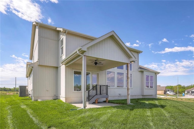 back of property featuring a lawn, ceiling fan, and central AC