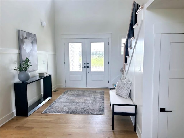 entryway with light wood-type flooring and french doors