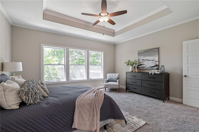 bedroom with ceiling fan, a raised ceiling, carpet floors, and ornamental molding