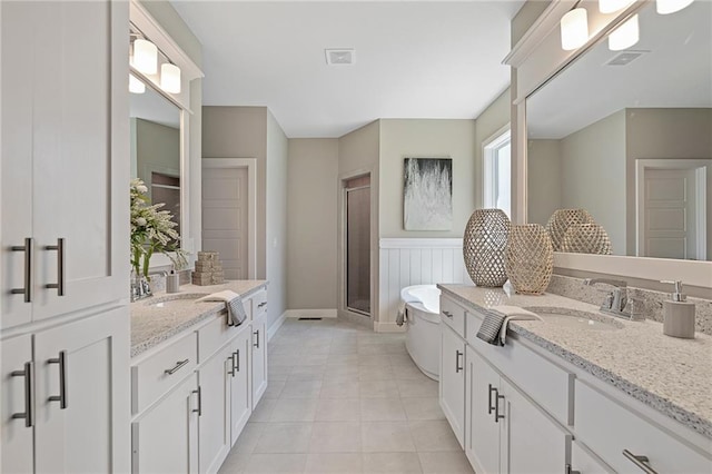 bathroom featuring vanity, tile patterned floors, and a shower with door