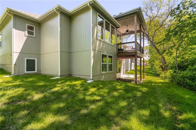 rear view of property with a yard and a wooden deck