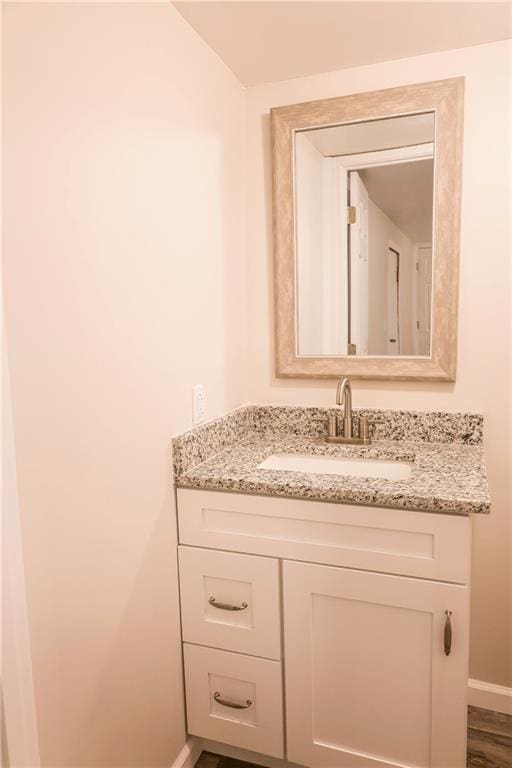 bathroom featuring hardwood / wood-style floors and vanity