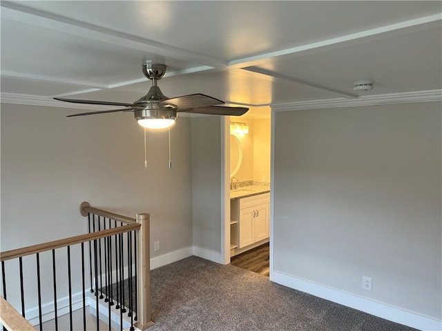 carpeted empty room featuring ceiling fan and ornamental molding