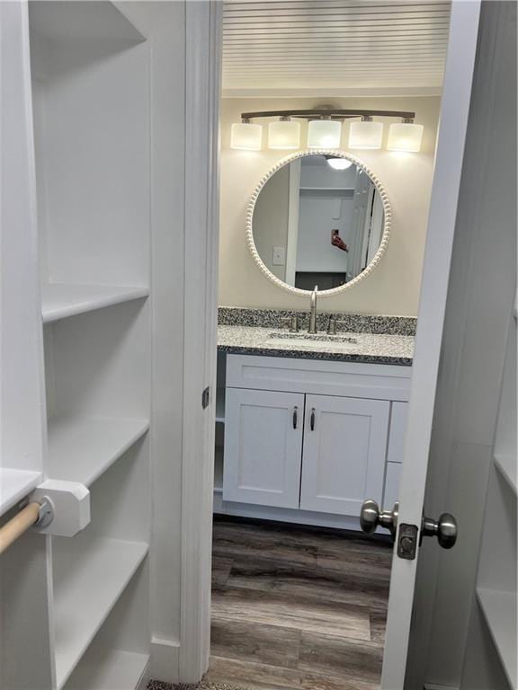 bathroom with hardwood / wood-style floors and vanity