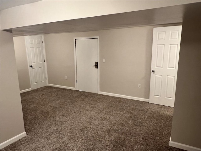 unfurnished room with dark colored carpet