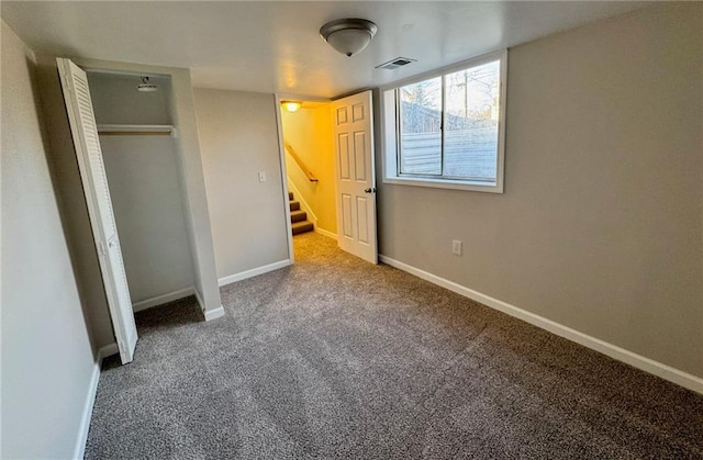 unfurnished bedroom featuring carpet flooring and a closet