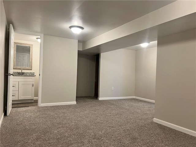 basement with carpet flooring and sink