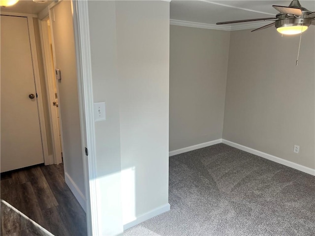 spare room featuring ceiling fan, crown molding, and dark wood-type flooring