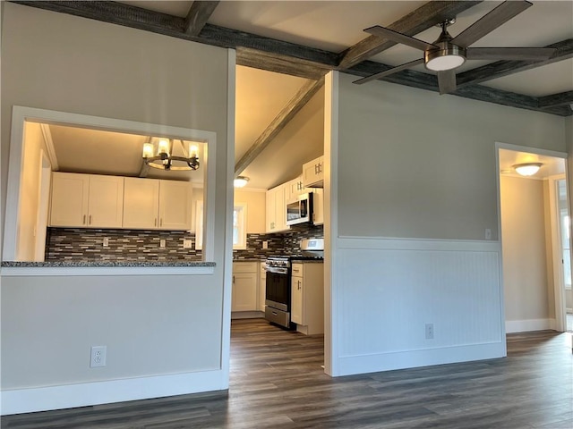 kitchen featuring decorative backsplash, ceiling fan with notable chandelier, stainless steel appliances, dark wood-type flooring, and white cabinetry