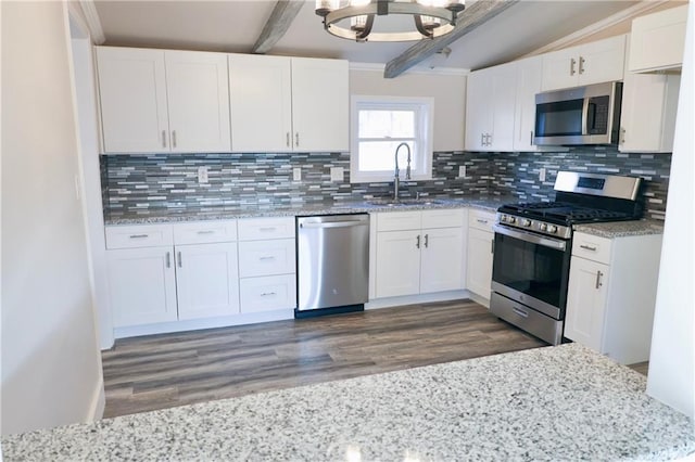 kitchen featuring backsplash, white cabinets, stainless steel appliances, and dark hardwood / wood-style floors