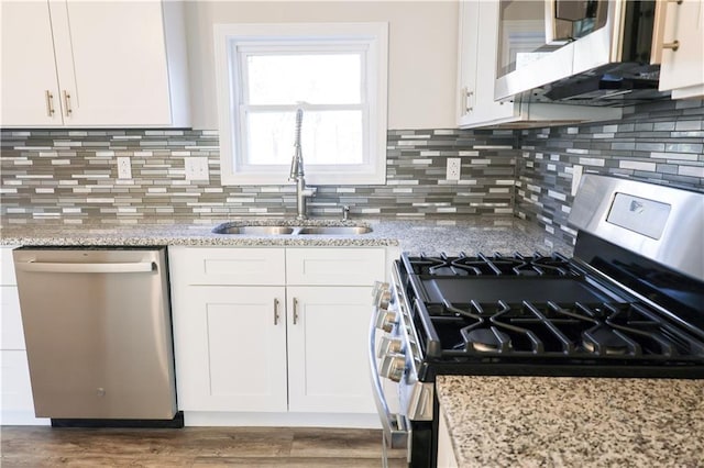 kitchen featuring light stone counters, white cabinetry, and appliances with stainless steel finishes