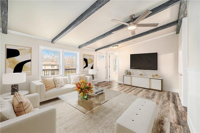 living room featuring hardwood / wood-style floors, lofted ceiling with beams, and ceiling fan