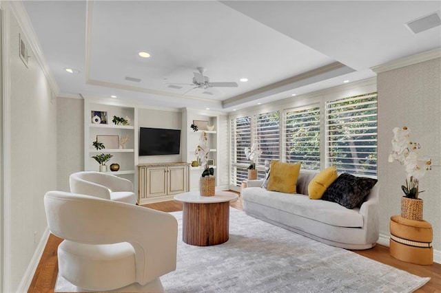433 Ward Pkwy Unit 3S, Kansas City, MO 64112 - living area featuring a raised ceiling, crown molding, light wood-style flooring, a ceiling fan, and recessed lighting