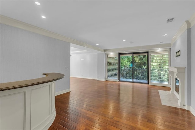 433 Ward Pkwy Unit 3S, Kansas City, MO 64112 - unfurnished living room with ornamental molding, hardwood / wood-style floors, a premium fireplace, and recessed lighting