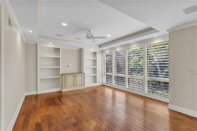 433 Ward Pkwy Unit 3S, Kansas City, MO 64112 - unfurnished room with healthy amount of natural light, ceiling fan, wood-type flooring, ornamental molding, and a raised ceiling