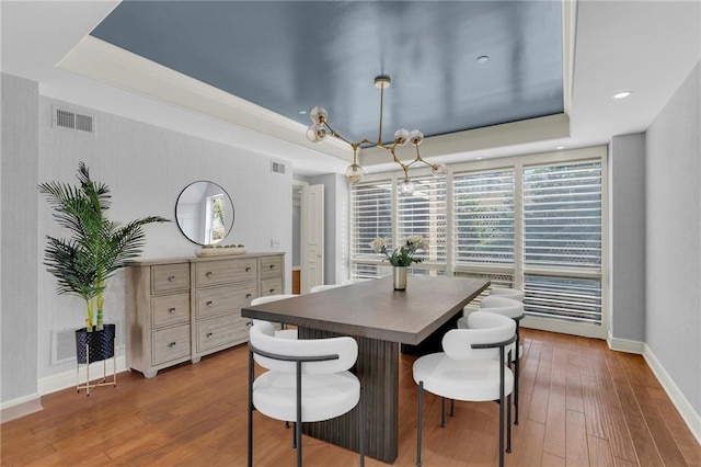 433 Ward Pkwy Unit 3S, Kansas City, MO 64112 - dining room with a raised ceiling, wood finished floors, and a chandelier