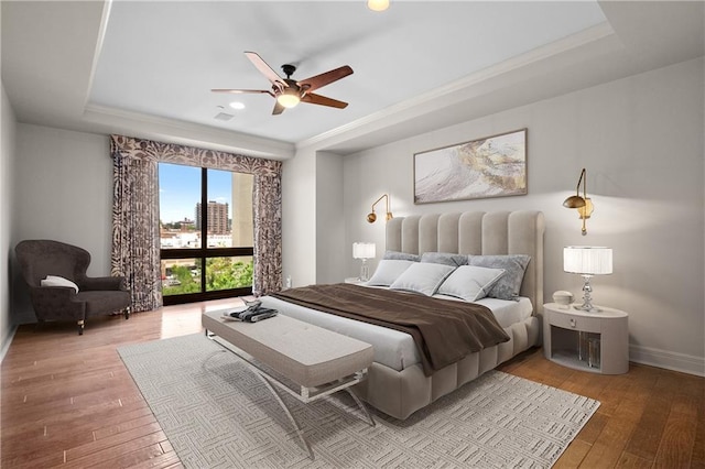 433 Ward Pkwy Unit 3S, Kansas City, MO 64112 - bedroom with a raised ceiling, light wood-type flooring, recessed lighting, ceiling fan, and crown molding