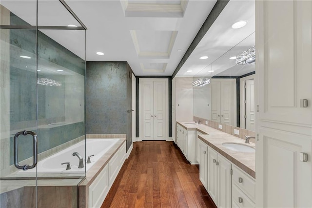 433 Ward Pkwy Unit 3S, Kansas City, MO 64112 - bathroom featuring two vanities, a garden tub, wood finished floors, recessed lighting, and a shower stall