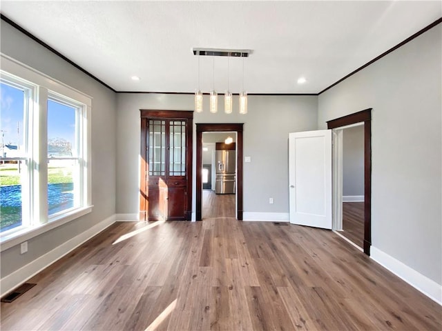 interior space featuring crown molding and hardwood / wood-style flooring