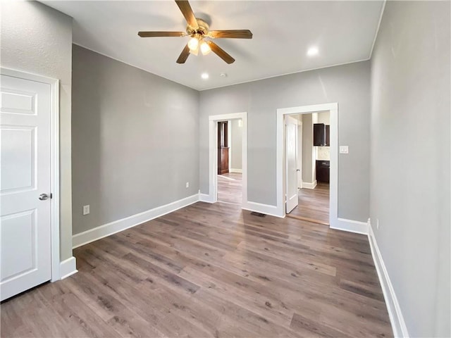 unfurnished bedroom featuring wood-type flooring and ceiling fan