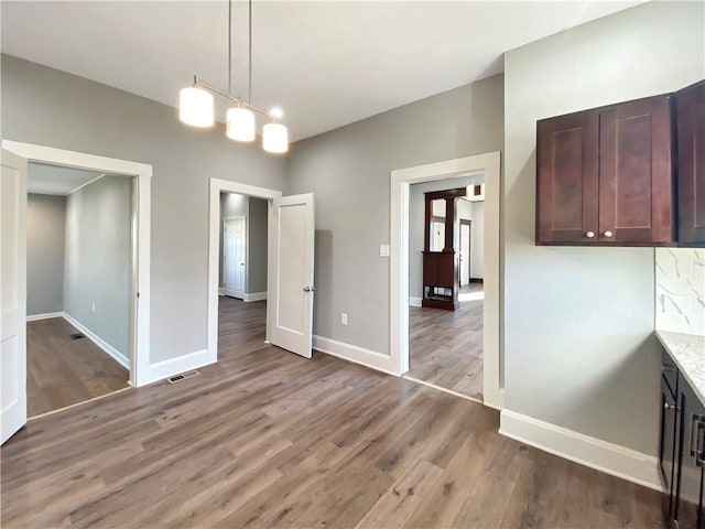 unfurnished dining area with wood-type flooring