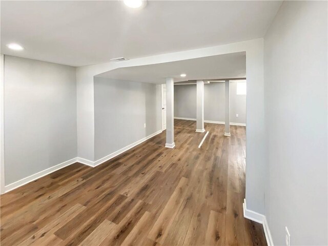 basement with hardwood / wood-style flooring