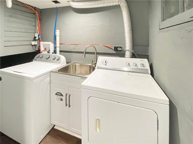 laundry area with separate washer and dryer, sink, and cabinets