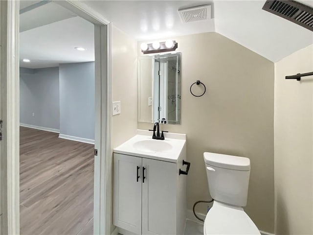 bathroom with vanity, hardwood / wood-style flooring, and toilet