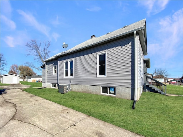 view of property exterior with cooling unit and a lawn