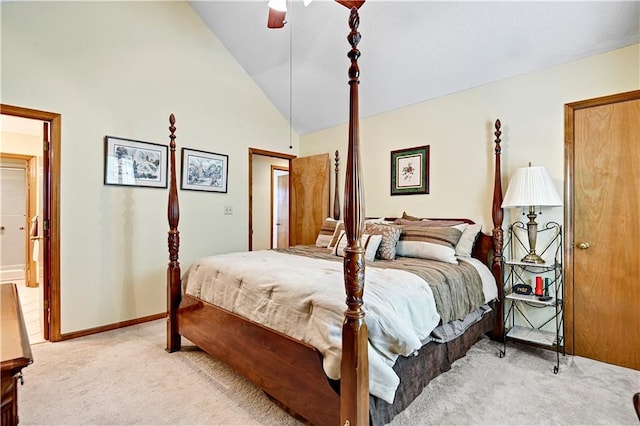 carpeted bedroom with ceiling fan and high vaulted ceiling