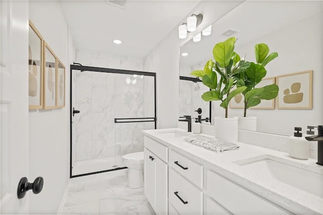 bathroom featuring vanity, an enclosed shower, and toilet