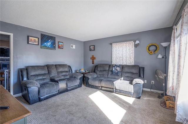 carpeted living area featuring visible vents and baseboards