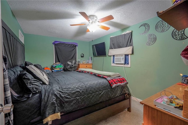 carpeted bedroom featuring ceiling fan, cooling unit, baseboards, and a textured ceiling