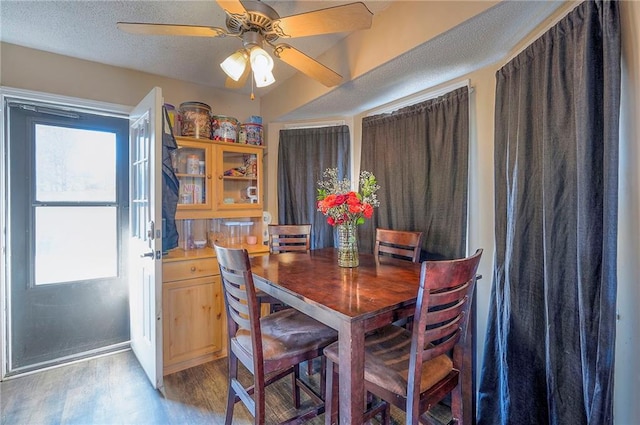 dining room with light wood-style flooring, a textured ceiling, and a ceiling fan