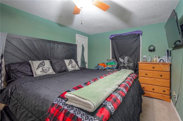 bedroom with a ceiling fan, carpet floors, and a textured ceiling