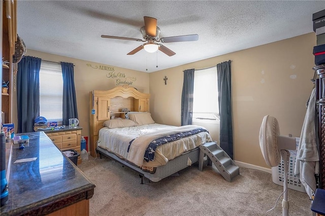 carpeted bedroom with baseboards, a textured ceiling, and a ceiling fan