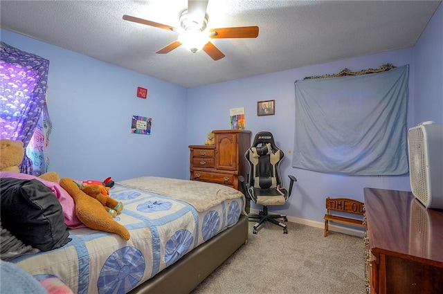 bedroom featuring light carpet, baseboards, a textured ceiling, and ceiling fan