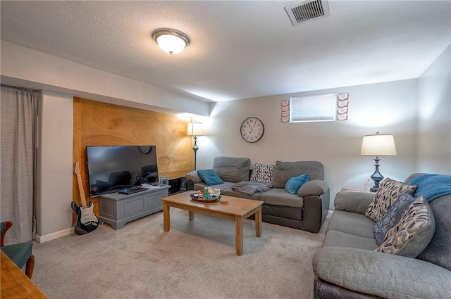 living room with light carpet, visible vents, a textured ceiling, and baseboards