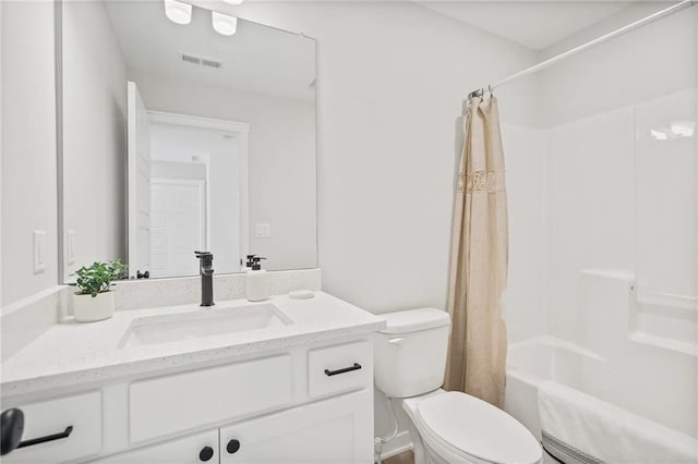 full bathroom with vanity, shower / bath combo, and toilet