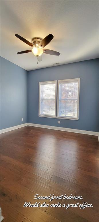 spare room featuring ceiling fan and dark hardwood / wood-style flooring