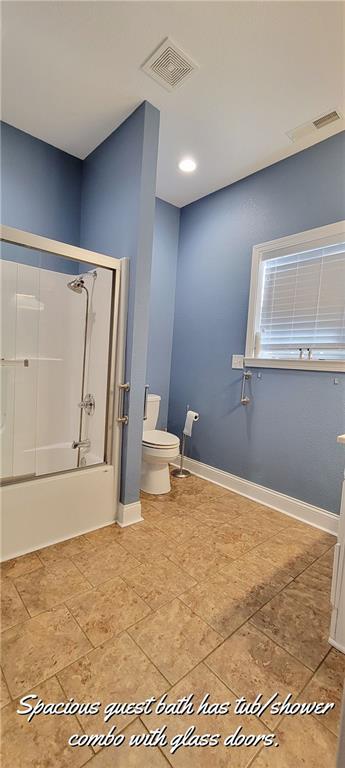 bathroom with toilet and shower / washtub combination