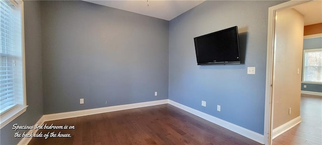 unfurnished room with dark hardwood / wood-style floors