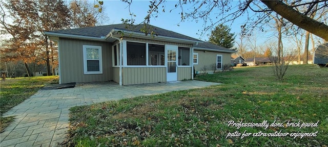 back of house with a yard, a patio, and a sunroom