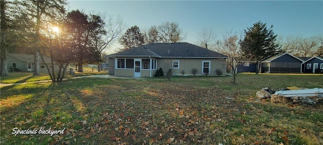 back house at dusk with a yard