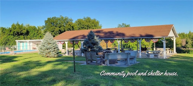 back of property with a lawn and a patio area