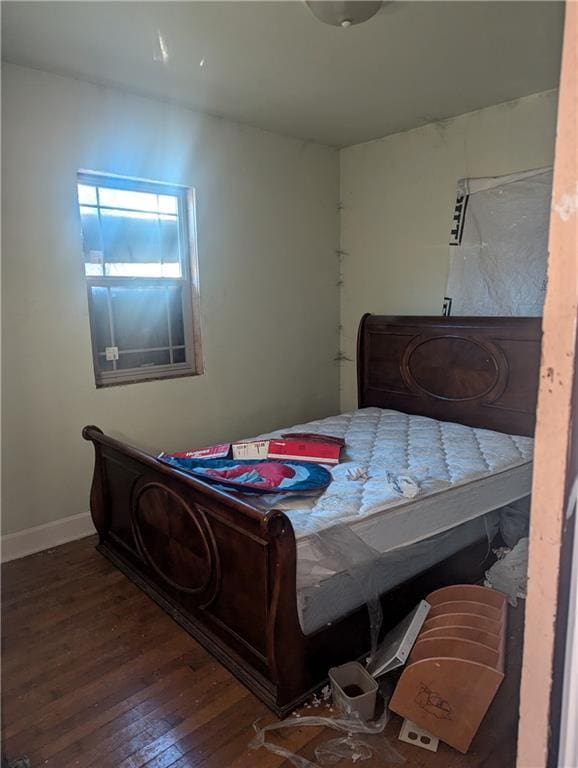 bedroom with dark hardwood / wood-style flooring