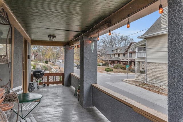 wooden deck with covered porch and grilling area